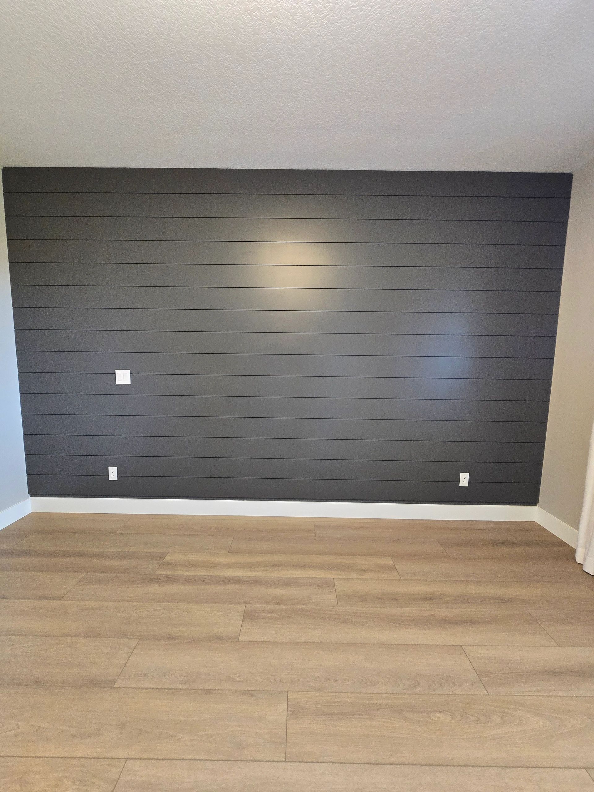 Dark shiplap accent wall installation
